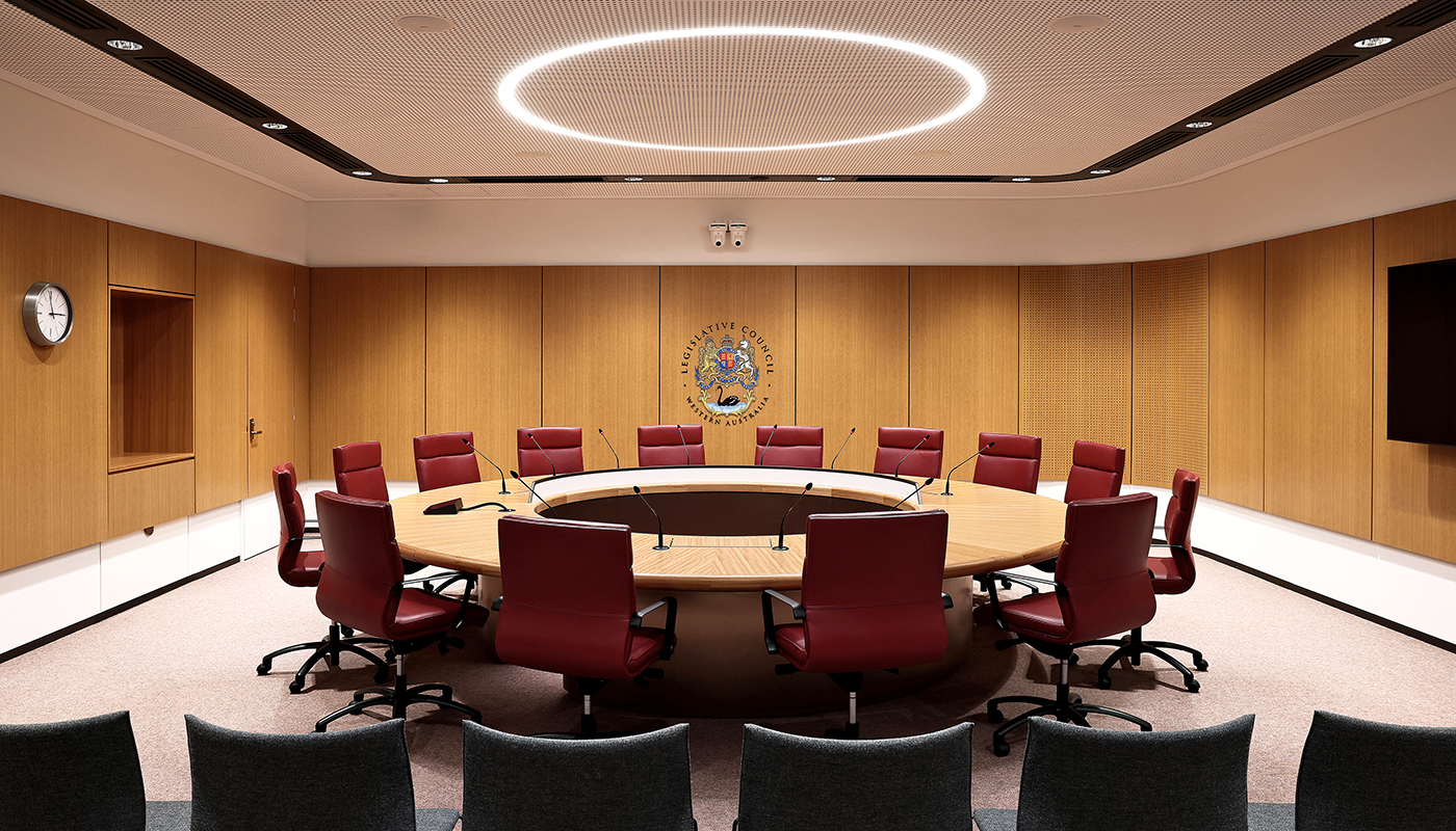 The interior design harmoniously integrates parliamentary tradition with modern functionality.